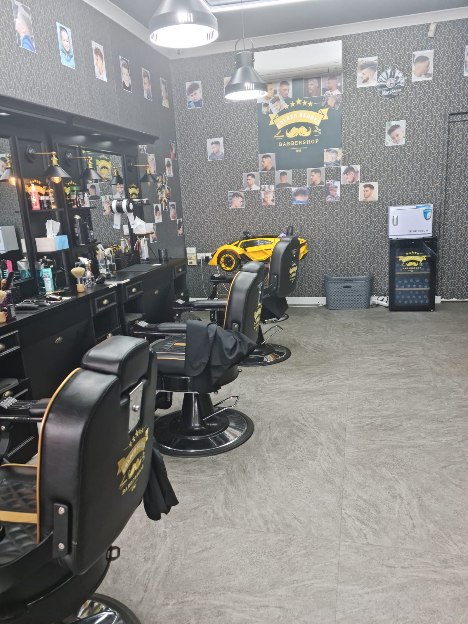 Row of barber chairs and workstations at Golden Blades 74