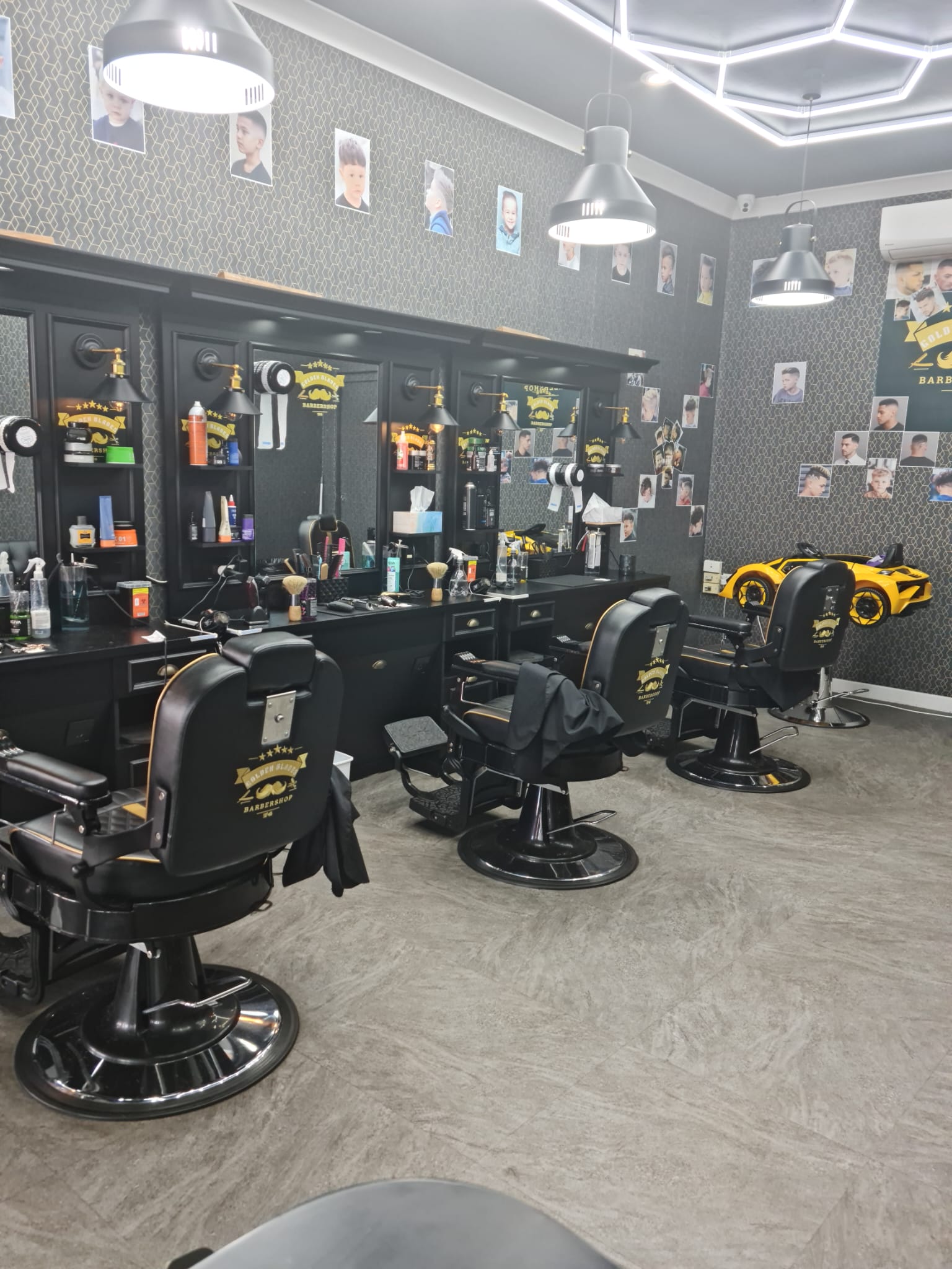 Multiple barber stations and styling chairs inside Golden Blades 74